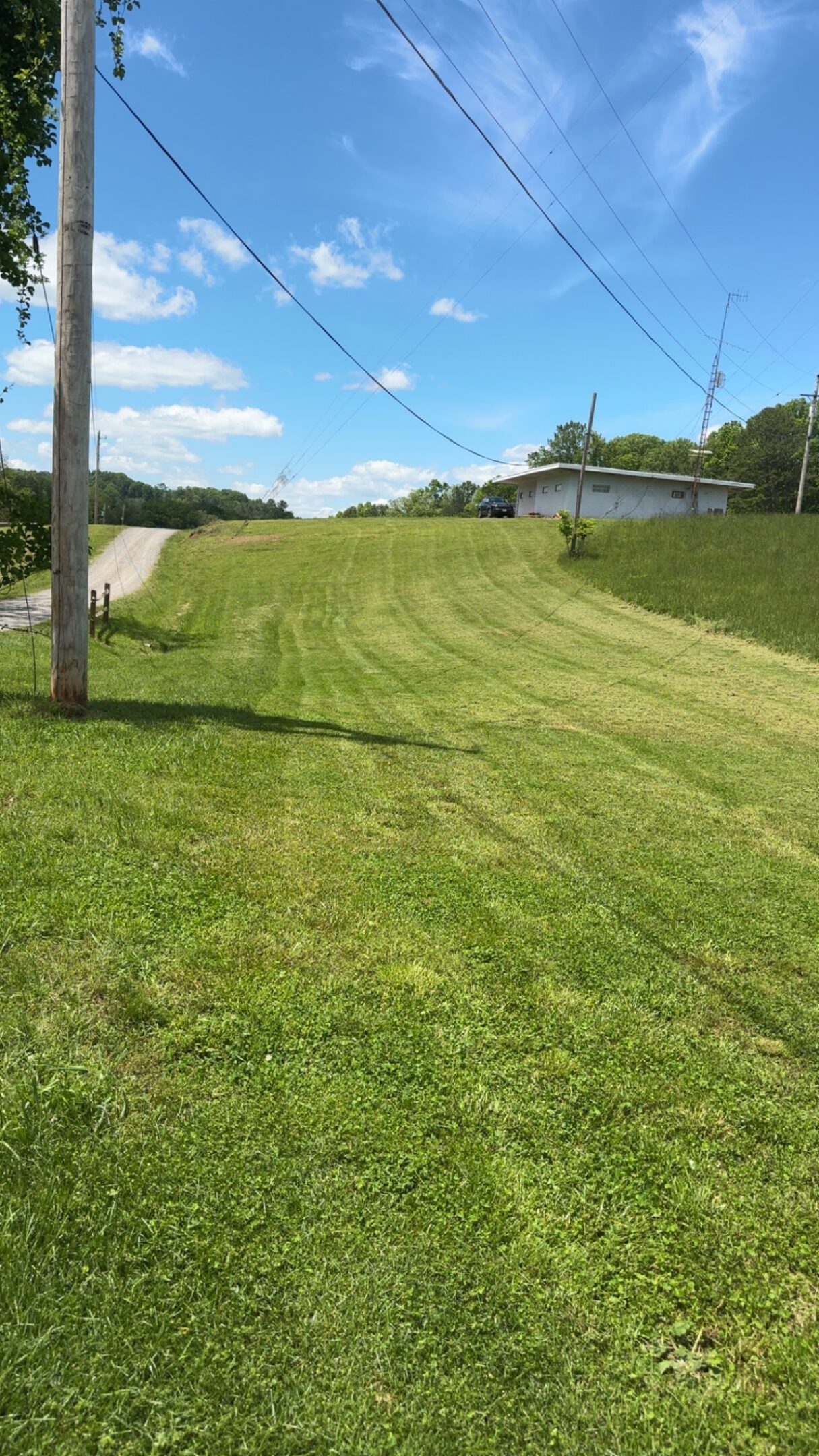 A freshly mowed grassy field under a clear sky.